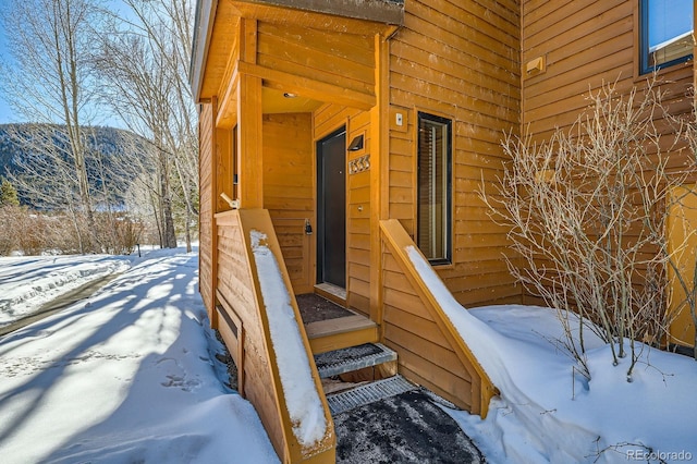 view of snow covered property entrance