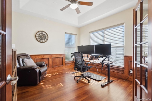 office area featuring a raised ceiling, hardwood / wood-style floors, and ceiling fan