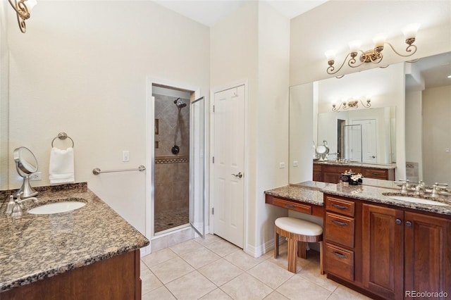 bathroom with an enclosed shower, vanity, and tile patterned floors