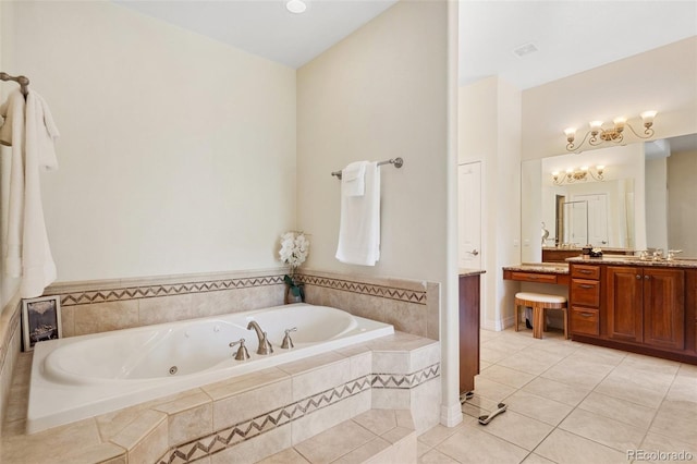 bathroom with vanity, tile patterned flooring, and tiled tub