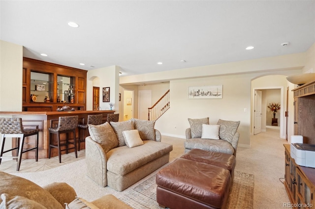 living room featuring bar and light carpet