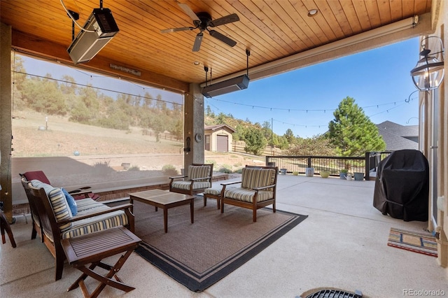 view of patio / terrace with area for grilling, an outdoor living space, a storage shed, and ceiling fan