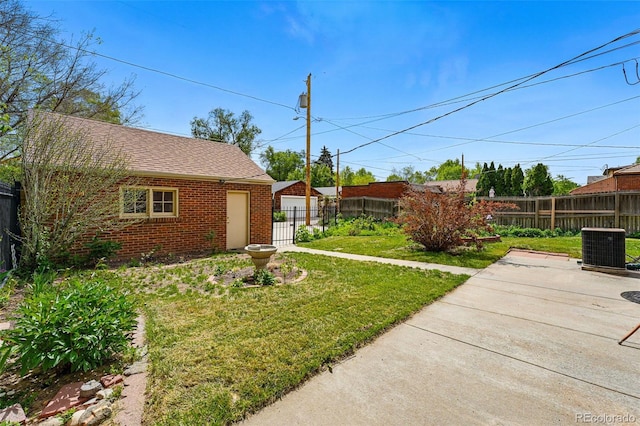 view of yard with central air condition unit and a patio