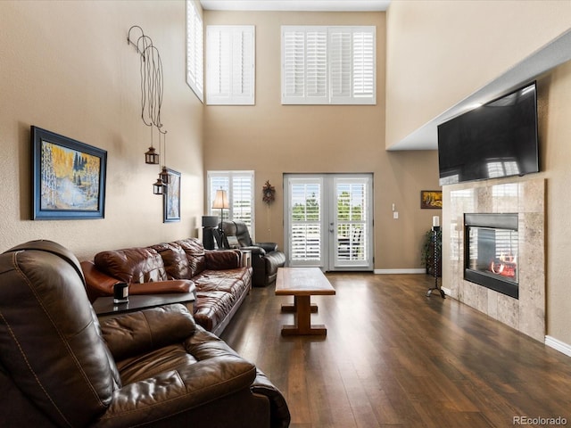 9323 Notts Ct, Lone Tree, CO 80124 - living room with wood finished floors, a tile fireplace, and a towering ceiling
