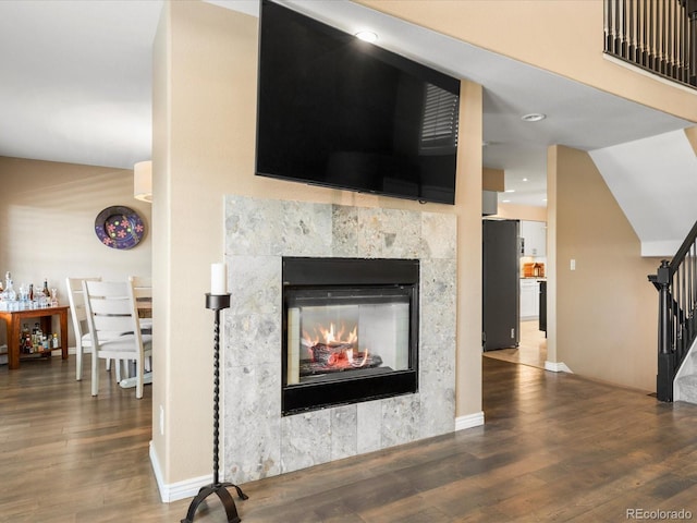 9323 Notts Ct, Lone Tree, CO 80124 - detailed view of freestanding refrigerator, wood finished floors, and a fireplace