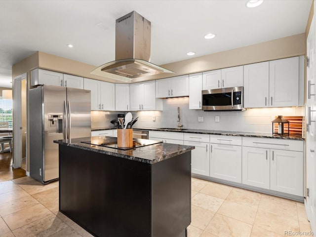 9323 Notts Ct, Lone Tree, CO 80124 - kitchen with appliances with stainless steel finishes, island exhaust hood, tasteful backsplash, dark stone countertops, and recessed lighting