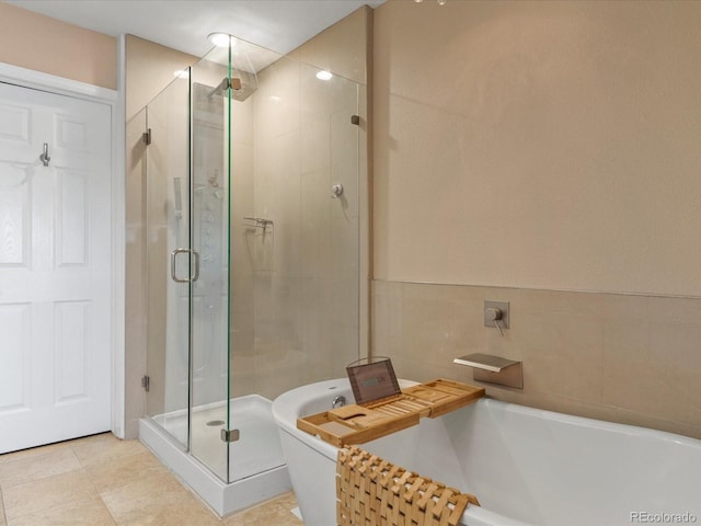9323 Notts Ct, Lone Tree, CO 80124 - bathroom featuring a soaking tub, a stall shower, and tile walls