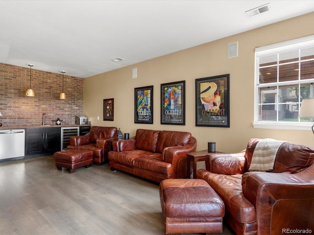 9323 Notts Ct, Lone Tree, CO 80124 - living room featuring beverage cooler, bar with sink, and wood finished floors
