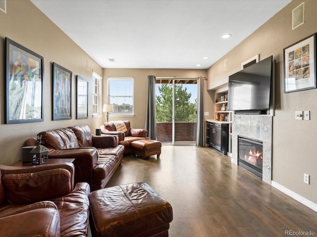 9323 Notts Ct, Lone Tree, CO 80124 - living room with wood finished floors, a tile fireplace, a textured wall, and recessed lighting