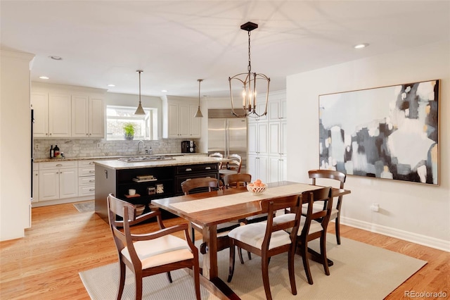 dining room featuring recessed lighting, baseboards, and light wood-style floors