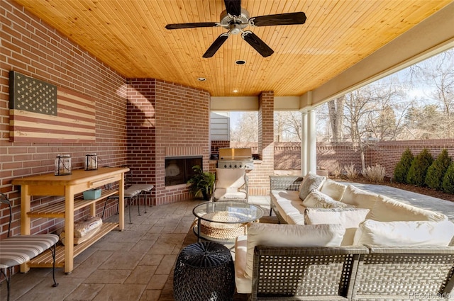 view of patio featuring an outdoor living space with a fireplace, area for grilling, ceiling fan, and fence