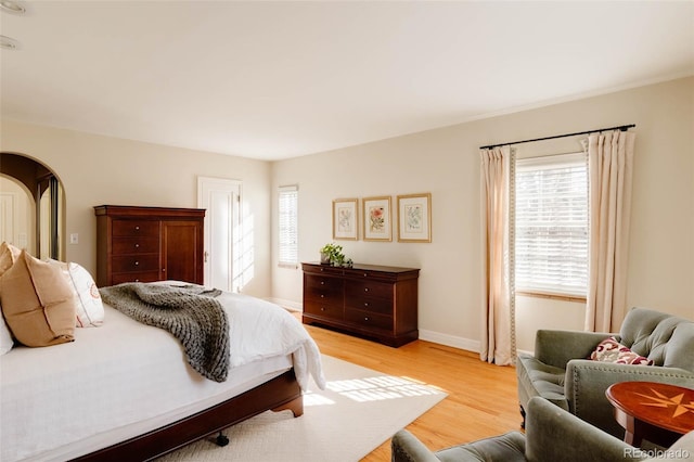 bedroom featuring light wood-type flooring and baseboards