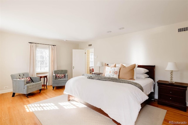 bedroom with visible vents and light wood-style flooring