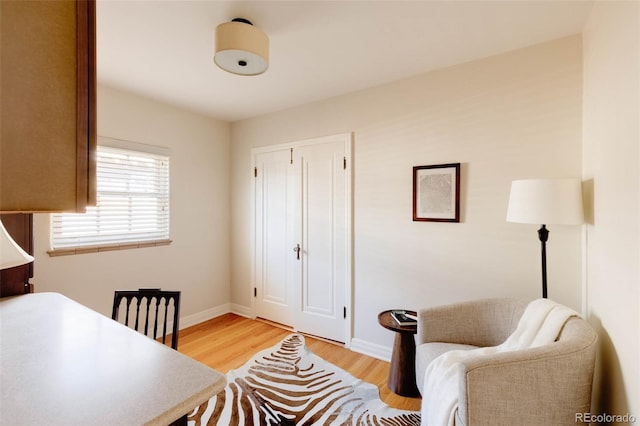 office with baseboards and light wood-style floors