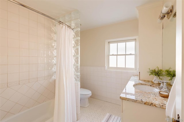 bathroom featuring shower / bath combo with shower curtain, toilet, tile walls, tile patterned flooring, and vanity