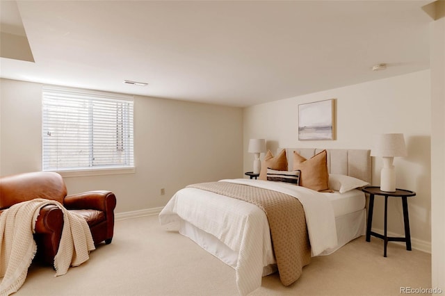 bedroom featuring light carpet, visible vents, and baseboards