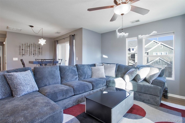 living room with hardwood / wood-style floors, a healthy amount of sunlight, and ceiling fan