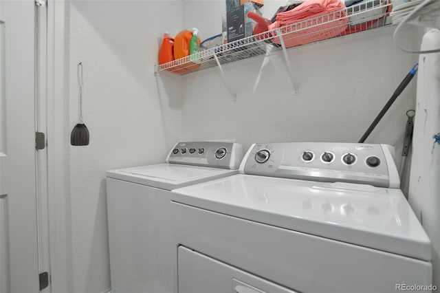 clothes washing area featuring washer and clothes dryer