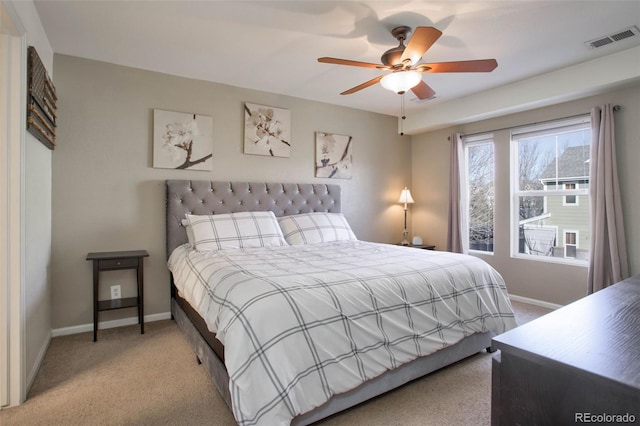 bedroom with ceiling fan and light carpet