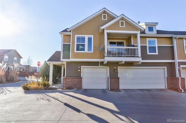 view of front of property featuring a garage and a balcony