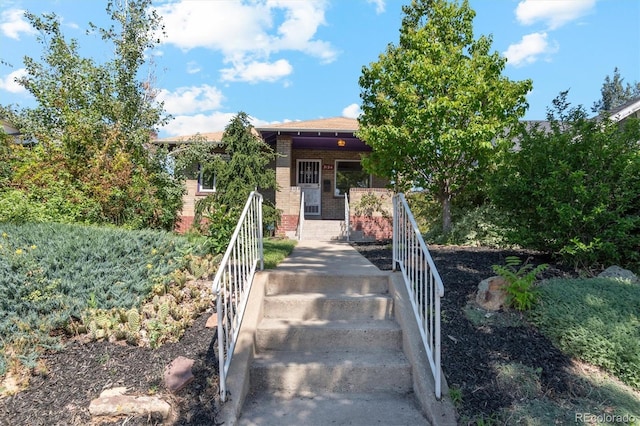 3154 N Columbine St, Denver, CO 80205 - view of front facade featuring brick siding and a porch