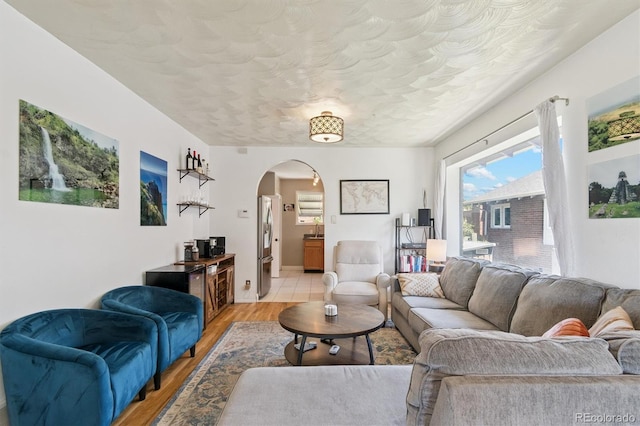 3154 N Columbine St, Denver, CO 80205 - living room featuring arched walkways and light wood-type flooring