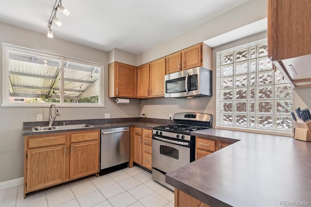 3154 N Columbine St, Denver, CO 80205 - kitchen featuring stainless steel appliances, healthy amount of natural light, dark countertops, and rail lighting