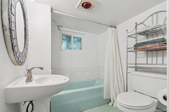 3154 N Columbine St, Denver, CO 80205 - bathroom featuring shower / tub combo with curtain and tile patterned floors