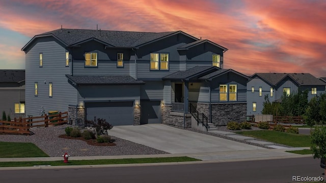 55 Morgan Cir, Erie, CO 80516 - view of front facade featuring stone siding, a garage, concrete driveway, and a shingled roof