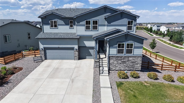 55 Morgan Cir, Erie, CO 80516 - view of front of home featuring an attached garage, stone siding, concrete driveway, roof with shingles, and a residential view