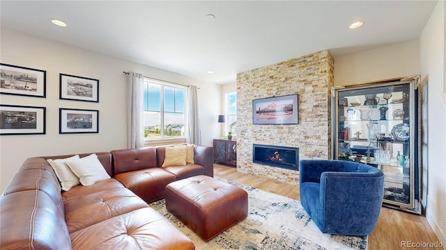 55 Morgan Cir, Erie, CO 80516 - living room featuring wood finished floors, a fireplace, and recessed lighting