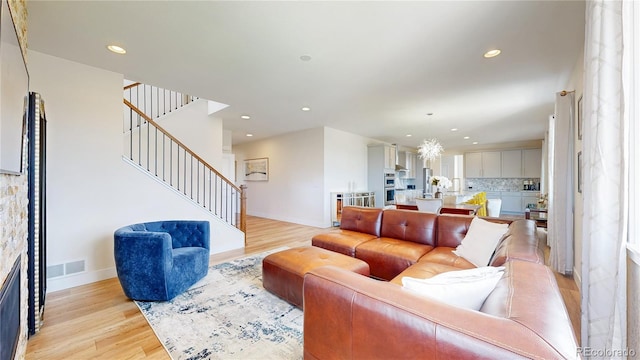 55 Morgan Cir, Erie, CO 80516 - living room featuring stairway, light wood-style floors, and recessed lighting