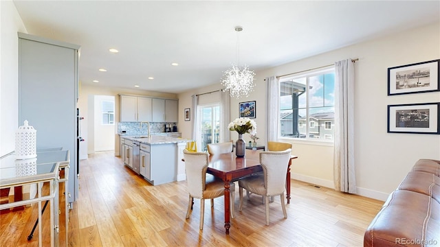 55 Morgan Cir, Erie, CO 80516 - dining space with light wood-style flooring, a chandelier, and recessed lighting