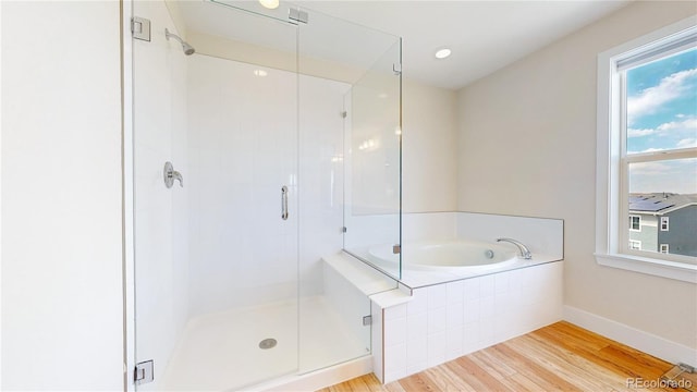55 Morgan Cir, Erie, CO 80516 - bathroom with wood finished floors, a shower stall, and a bath