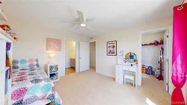 55 Morgan Cir, Erie, CO 80516 - bedroom featuring light carpet, ceiling fan, a walk in closet, and ensuite bathroom