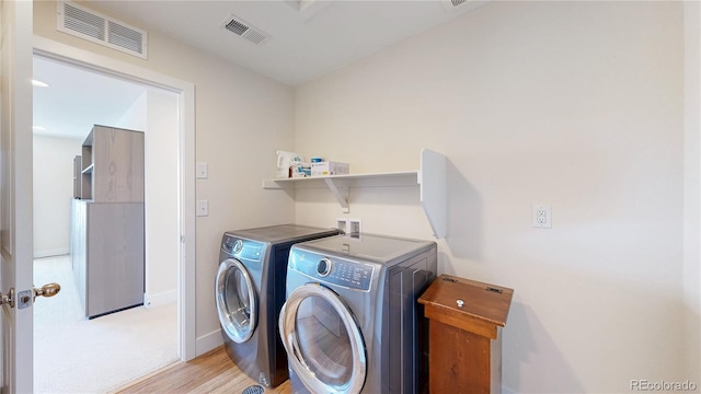 55 Morgan Cir, Erie, CO 80516 - laundry area featuring washer and clothes dryer and light wood-type flooring