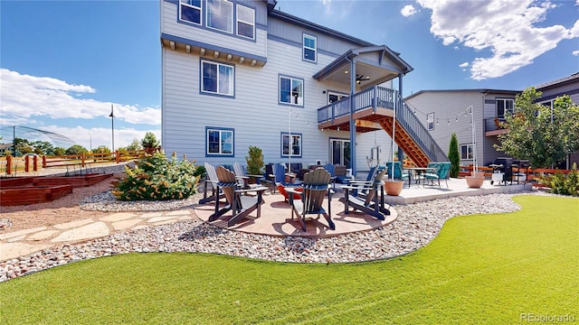 55 Morgan Cir, Erie, CO 80516 - rear view of house featuring stairs, a patio, and a lawn