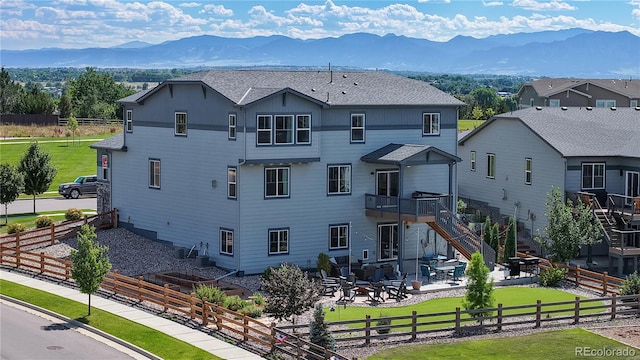 55 Morgan Cir, Erie, CO 80516 - view of property featuring a fenced backyard, a mountain view, and stairs