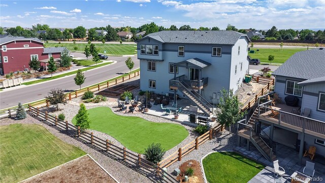 55 Morgan Cir, Erie, CO 80516 - rear view of house with stairs, a fenced backyard, and a deck