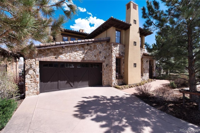 8002 Galileo Way, Littleton, CO 80125 - view of side of property featuring stucco siding, stone siding, a chimney, and concrete driveway