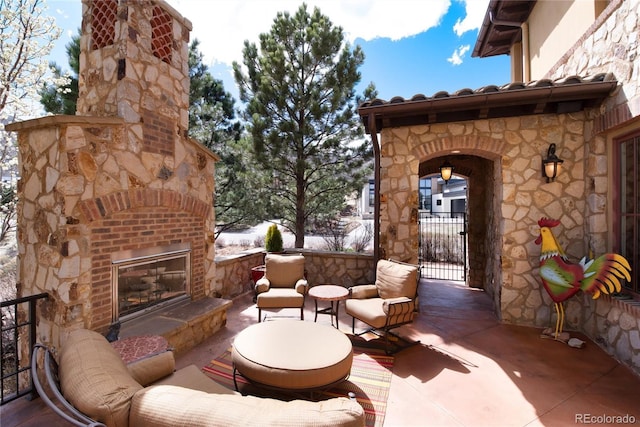 8002 Galileo Way, Littleton, CO 80125 - view of patio featuring a gate and an outdoor living space with a fireplace