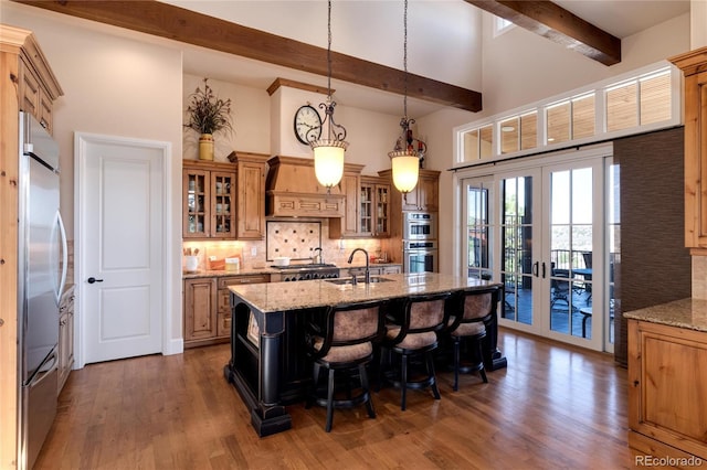8002 Galileo Way, Littleton, CO 80125 - kitchen with a towering ceiling, stainless steel appliances, backsplash, a sink, and beamed ceiling