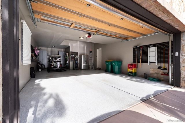 8002 Galileo Way, Littleton, CO 80125 - garage with freestanding refrigerator and a garage door opener