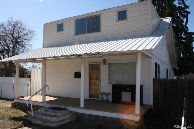 back of house with fence and a wooden deck