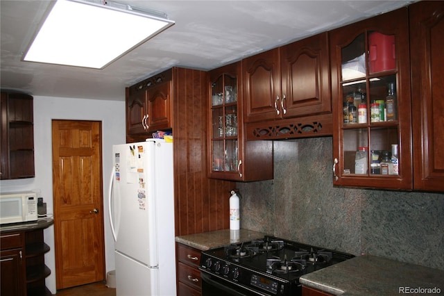 kitchen featuring white appliances, tasteful backsplash, glass insert cabinets, and open shelves