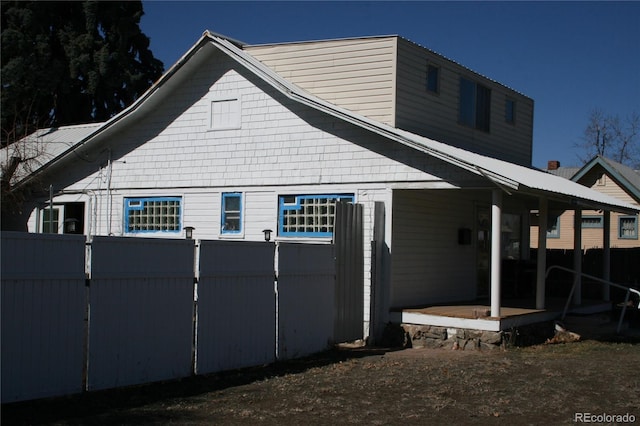 view of property exterior featuring a patio area and fence