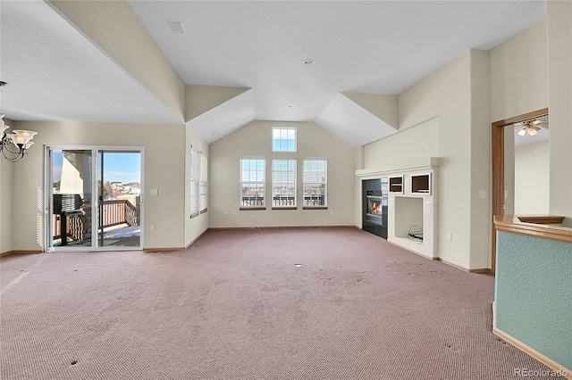 unfurnished living room with carpet flooring and vaulted ceiling