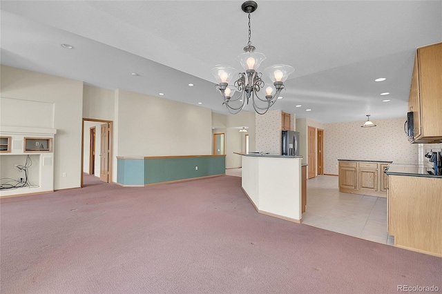 kitchen featuring a notable chandelier, light brown cabinetry, decorative light fixtures, refrigerator with ice dispenser, and light colored carpet