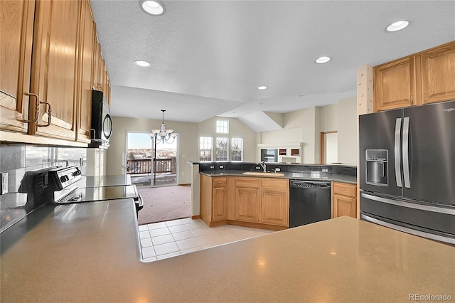 kitchen with kitchen peninsula, hanging light fixtures, appliances with stainless steel finishes, light tile patterned flooring, and an inviting chandelier