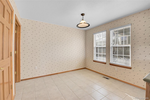 unfurnished room with light tile patterned floors